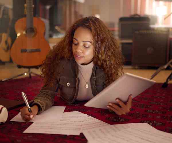 Musician, Studio and Woman Writing Lyrics for a Song with Paper and a Digital Tablet for Composition. Creative, Composer and Female Musical Artist from Mexico Working on a Album, Sound Track or Sound