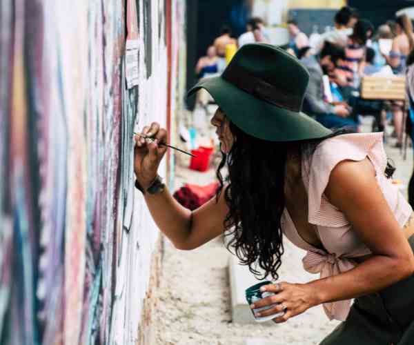 Photo of Woman Painting on Wall